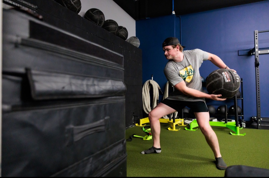 Baseball player winding up for a rotational medicine ball throw