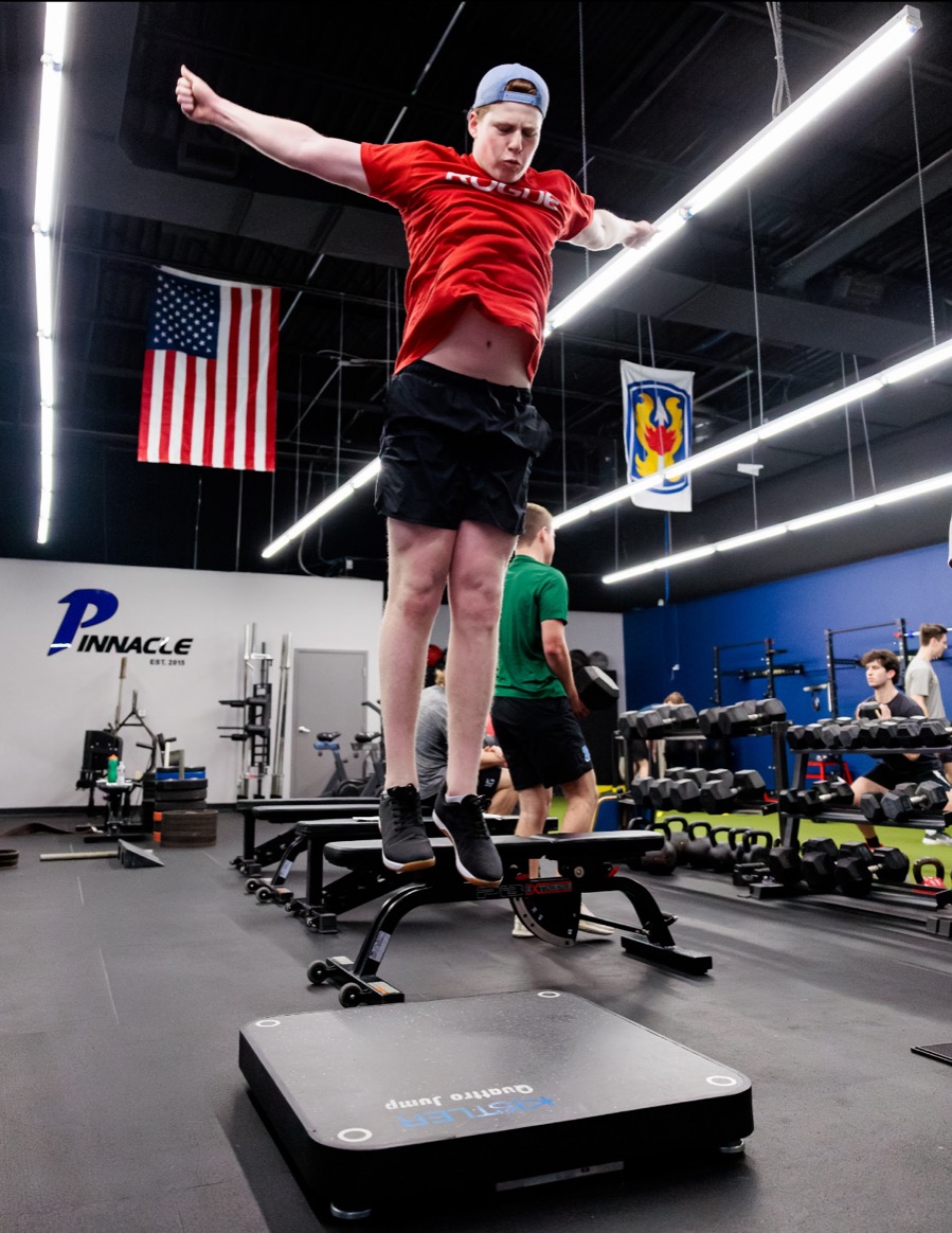 Athlete jumping off a bench onto a Kistler force plate at Pinnacle